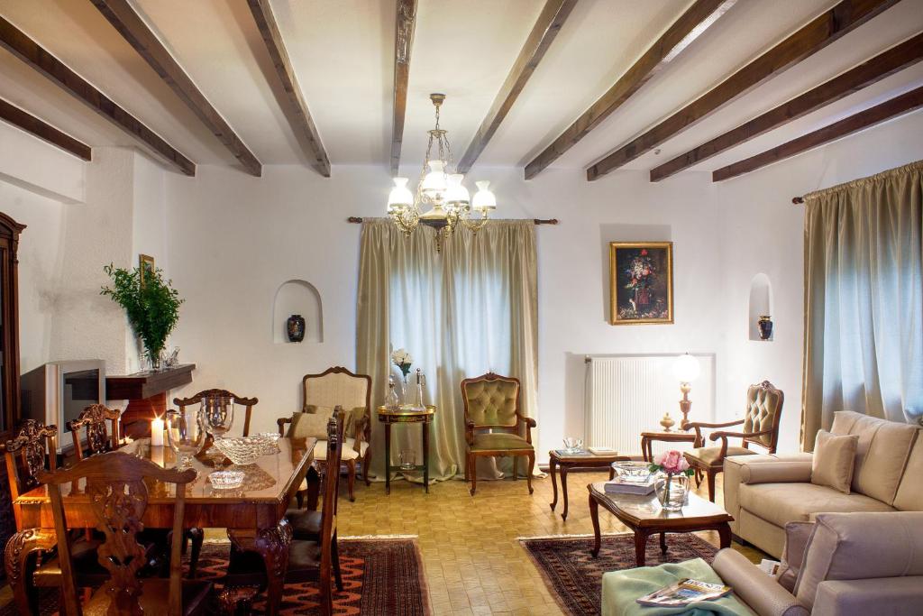 a living room with a couch and a table at Philippe chateau in Krepeni