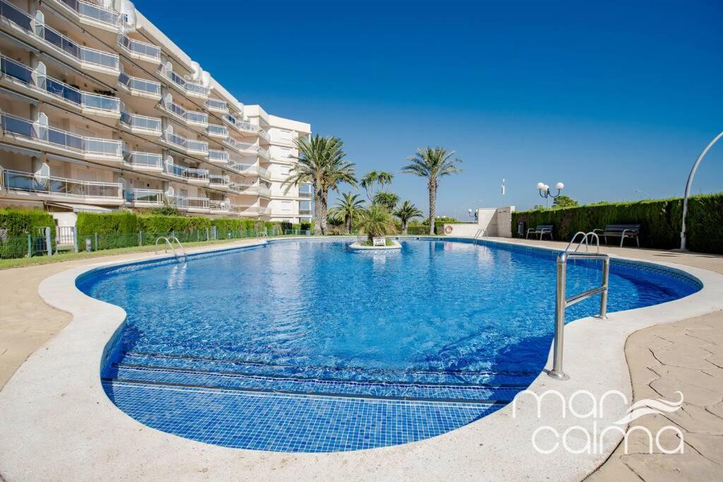 a large swimming pool in front of a building at Apto. Bellavista by MarCalma in Miami Platja