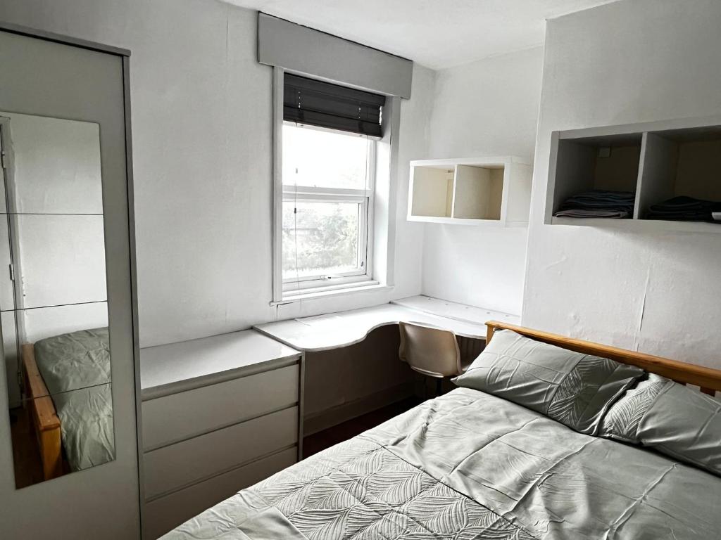 a small bedroom with a bed and a window at 36 park road house in Nottingham