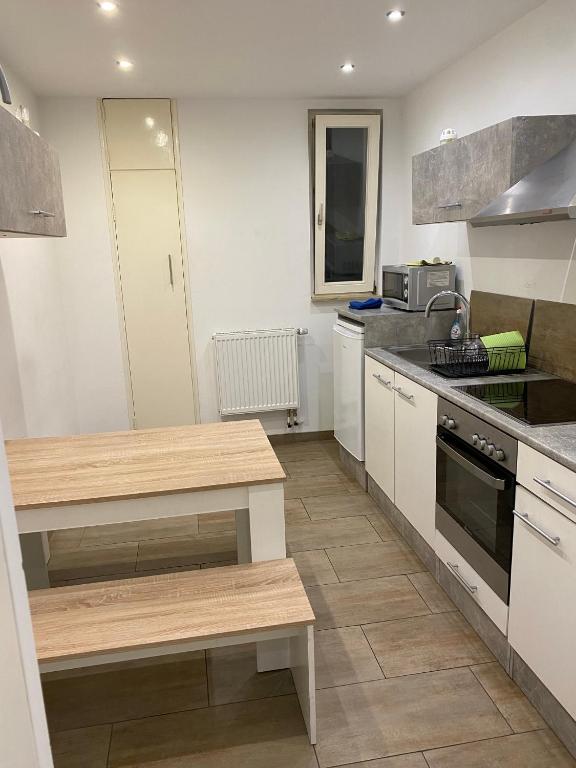 a kitchen with white cabinets and a counter top at Szenetreff City in Würzburg