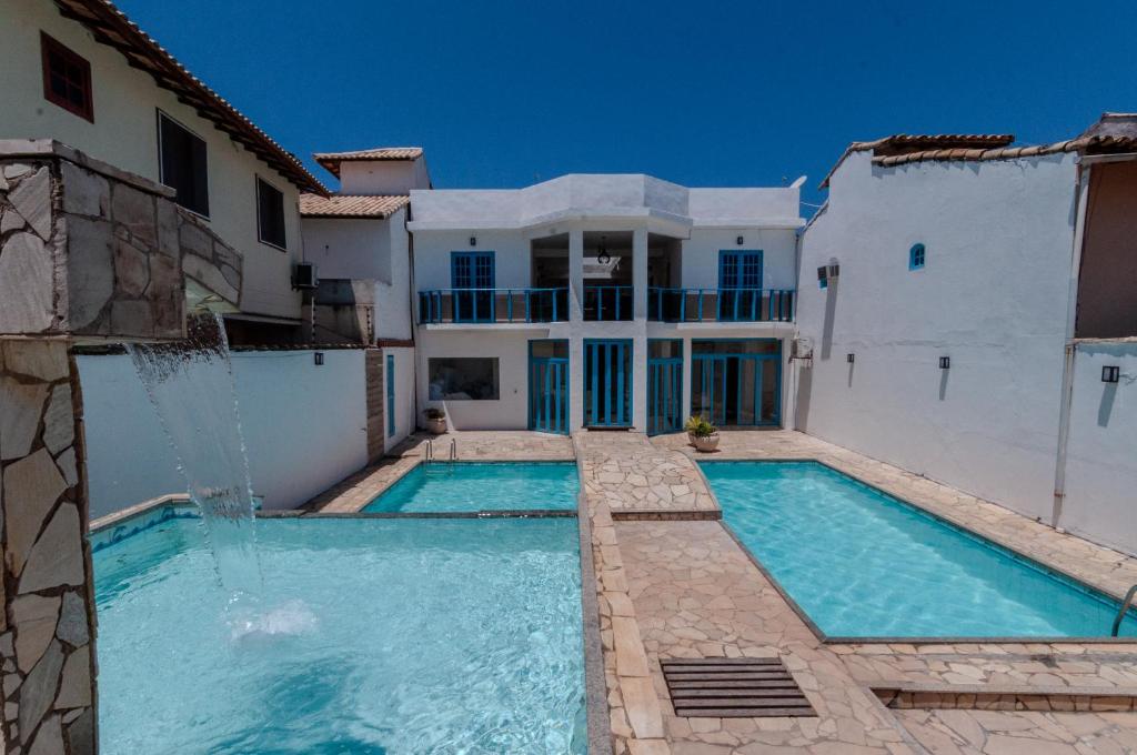a swimming pool in front of a house at Pousada Mar de Geribá in Búzios