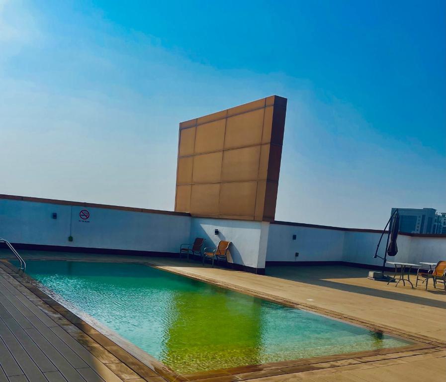 a swimming pool on the roof of a building at Ayo’s apartment in Dubai