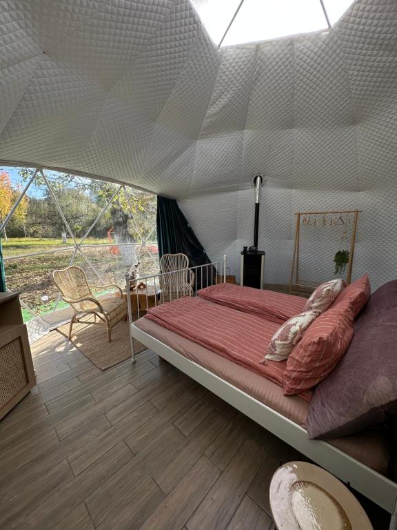 um quarto com uma cama numa tenda em The Frog Glamping em Horezu