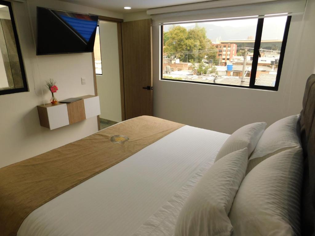 Postel nebo postele na pokoji v ubytování HOTEL MX BOGOTA