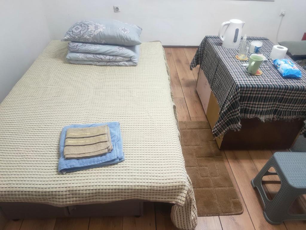 two beds sitting next to each other on a wooden floor at Warm and comfortable apartment in Subotica