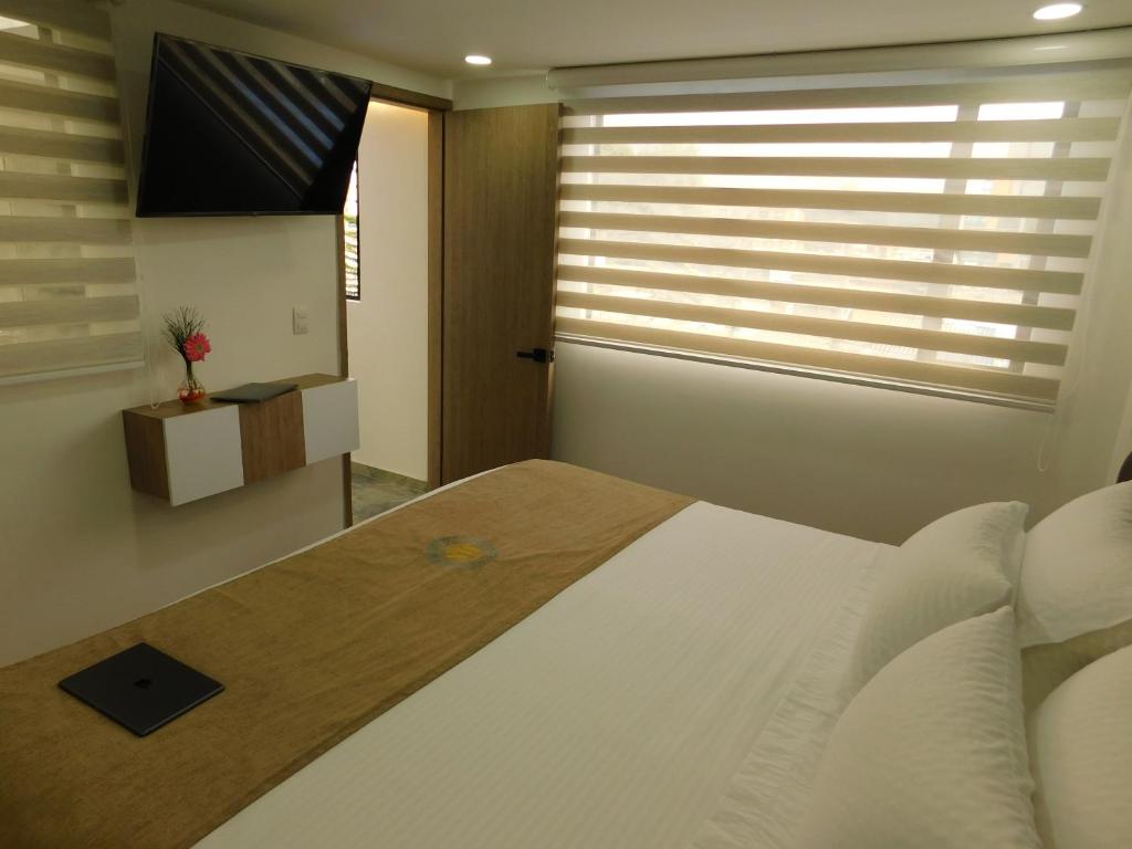 Postel nebo postele na pokoji v ubytování HOTEL MX BOGOTA