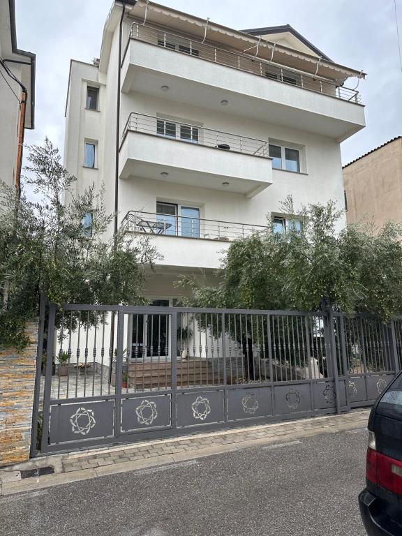 a building with a gate in front of it at Brilant Apartament in Tirana