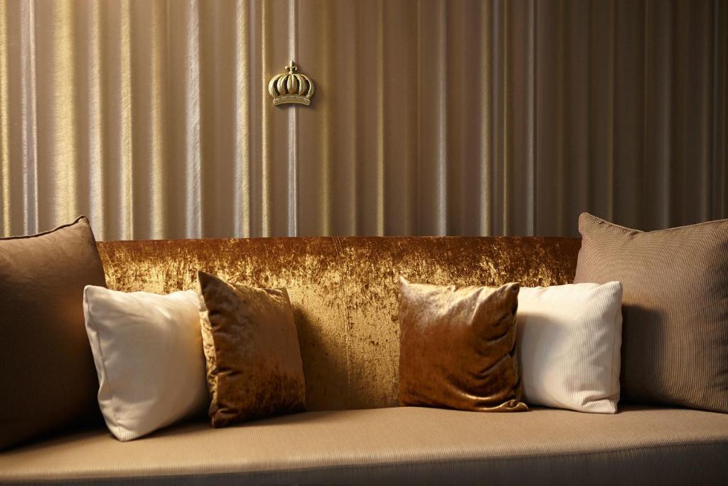 a couch with several pillows on top of it at Hotel AVA in Sempach Station