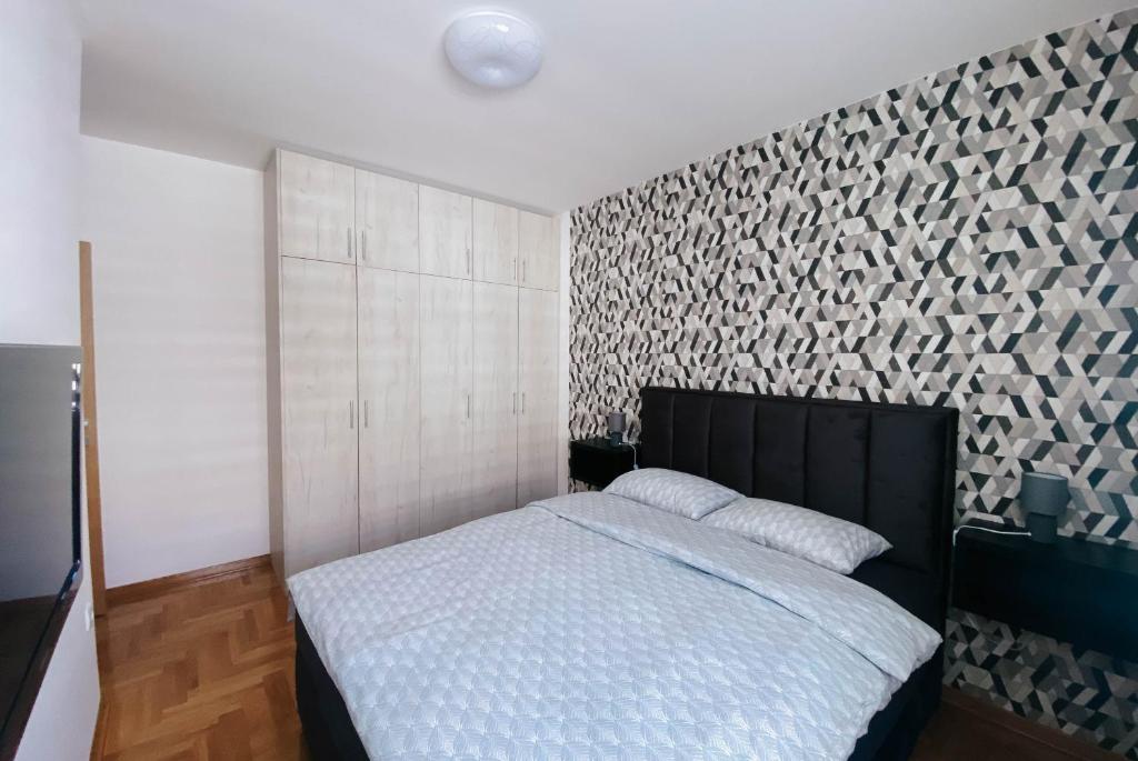 Voodi või voodid majutusasutuse Apartmani Milan toas