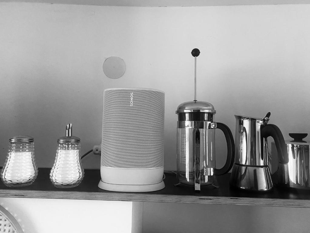 a counter with a coffee maker and other appliances on it at Loft mit Dachterrasse in Bernau am Chiemsee