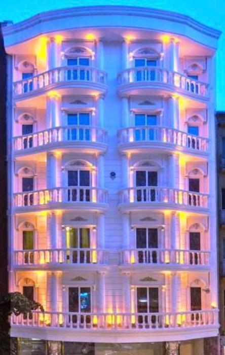 a large white building with a lit up facade at Darkmen Hotel 2 in Istanbul