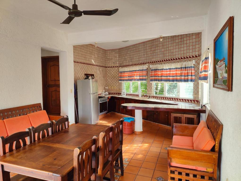a kitchen with a table and chairs and a refrigerator at Villa Isabel 2 in Tangolunda