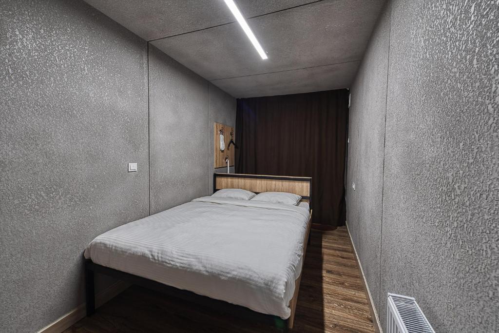 a small bedroom with a bed in a room at ИксаОтель in Shymkent