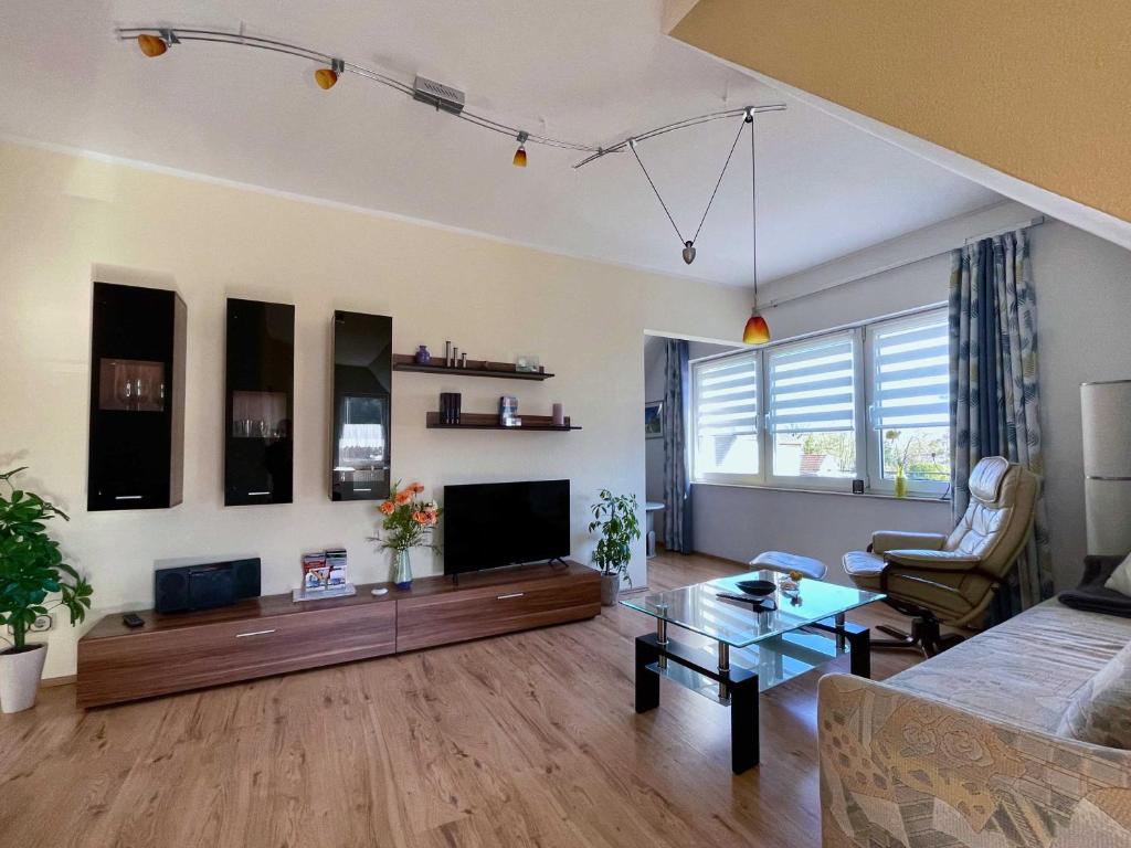 a living room with a couch and a tv at Apartment Rotes Haus in Kröslin