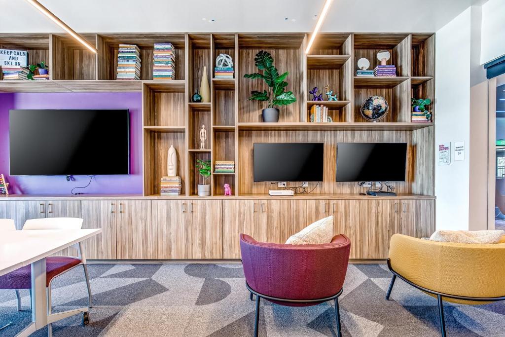 un salon avec deux chaises et une télévision dans l'établissement Canyons Resort Village #129, à Park City