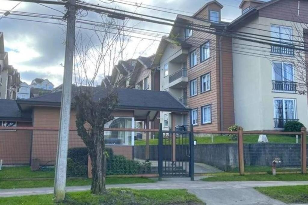 a house with a fence in front of it at Departamento 2d1b Puerto Varas in Puerto Varas