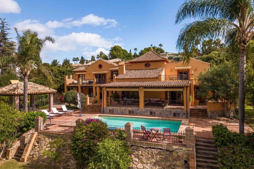 a home with a swimming pool and a house at Casa del Paraiso in Estepona