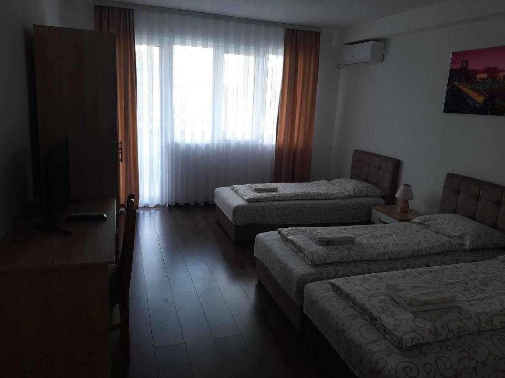 Postel nebo postele na pokoji v ubytování Apartmani Centar