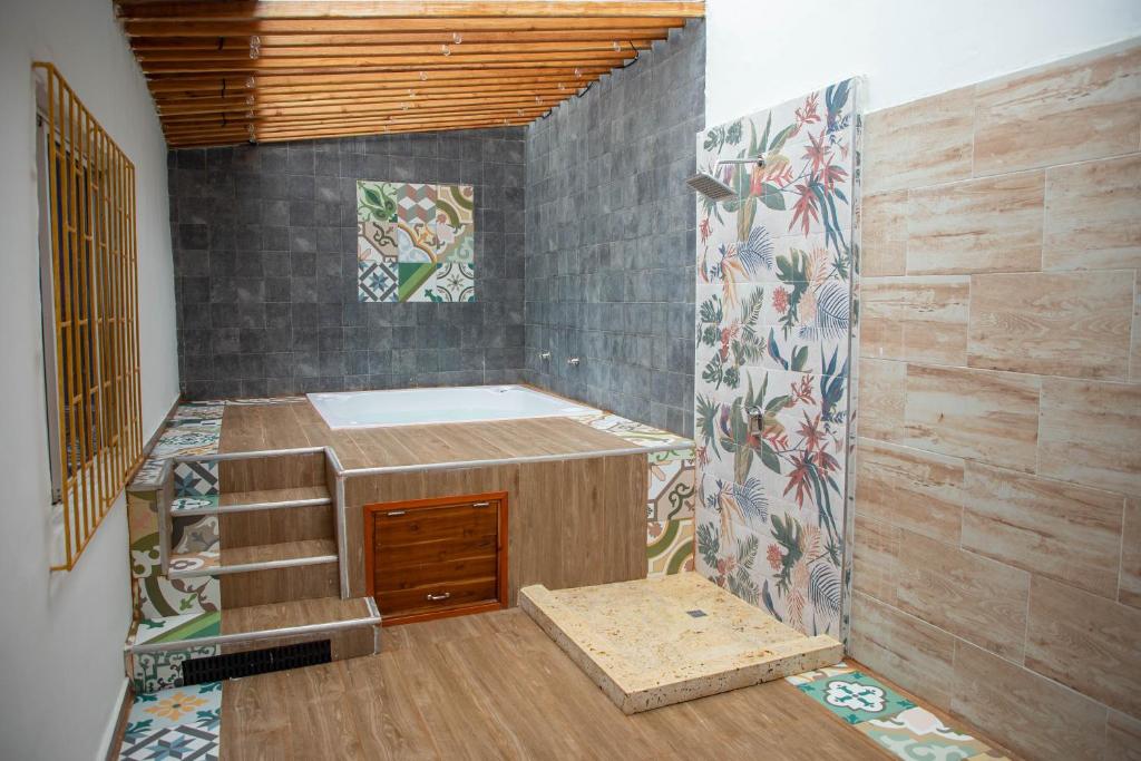 a bathroom with a shower with a sink and a staircase at CASA PETRA in Cartagena de Indias