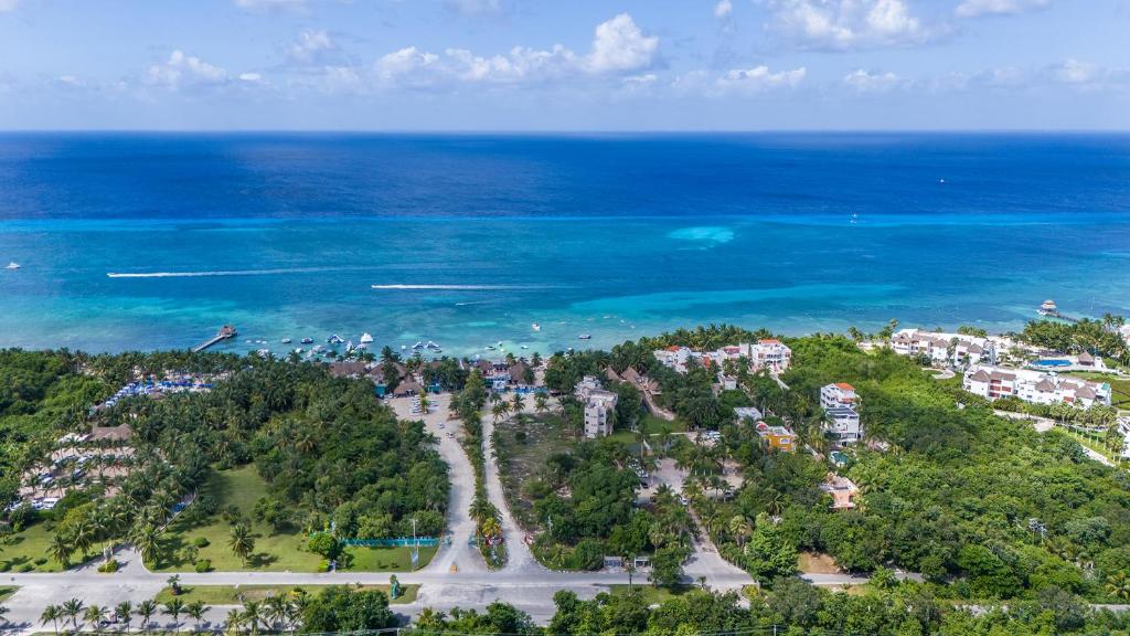 an aerial view of a resort near the ocean at Maia Suites Cozumel in Cozumel