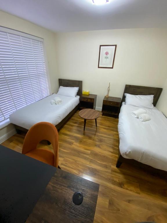 een kamer met twee bedden en een tafel erin bij Silk Hotel in Boston