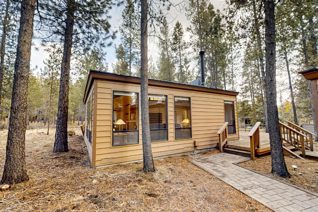 a small cabin in the woods with trees at Jackalope Manor in Sunriver