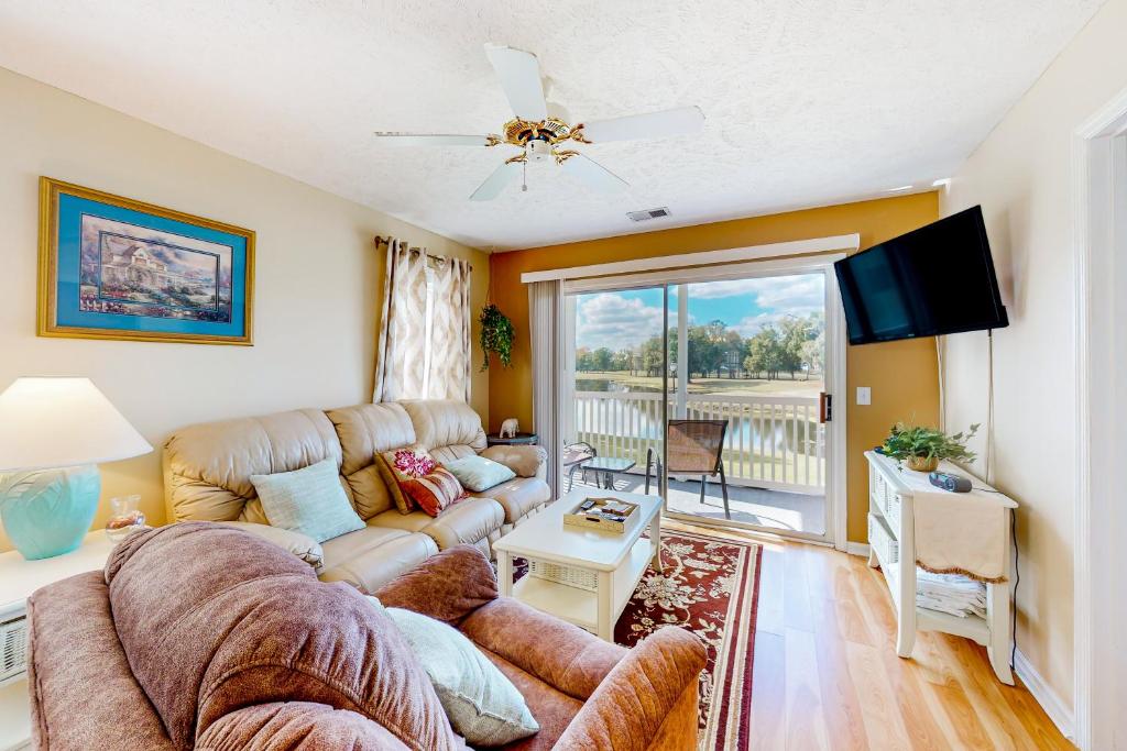 a living room with a couch and a tv at River Oaks 10D in Myrtle Beach