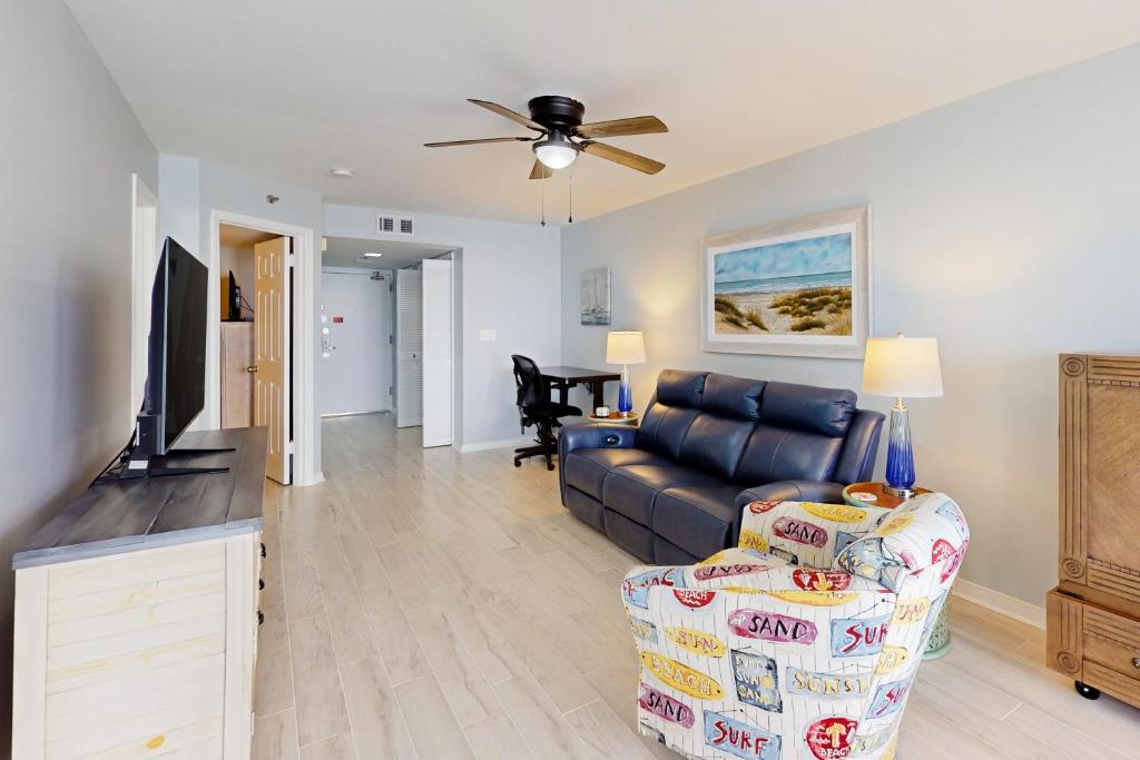 a living room with a couch and a ceiling fan at Phoenix IV 4052 in Orange Beach