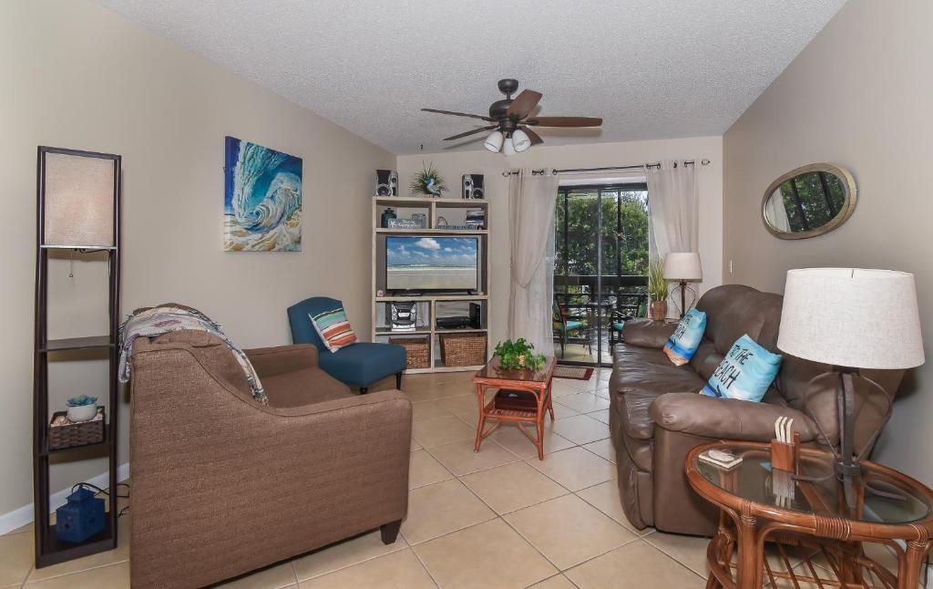 a living room with leather furniture and a ceiling fan at Beautifully updated Sea Woods Condo near main pool and beach access - SC248 in Edgewater