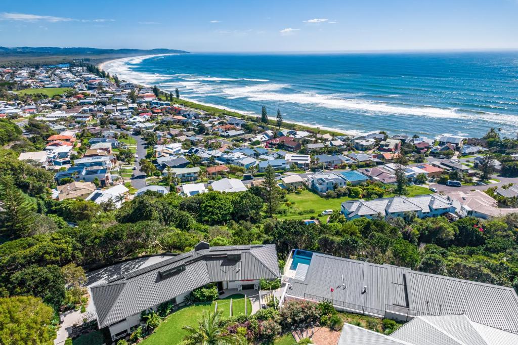 an aerial view of a coastal town with houses and the ocean at Wave Hill and The Pool House in Lennox Head