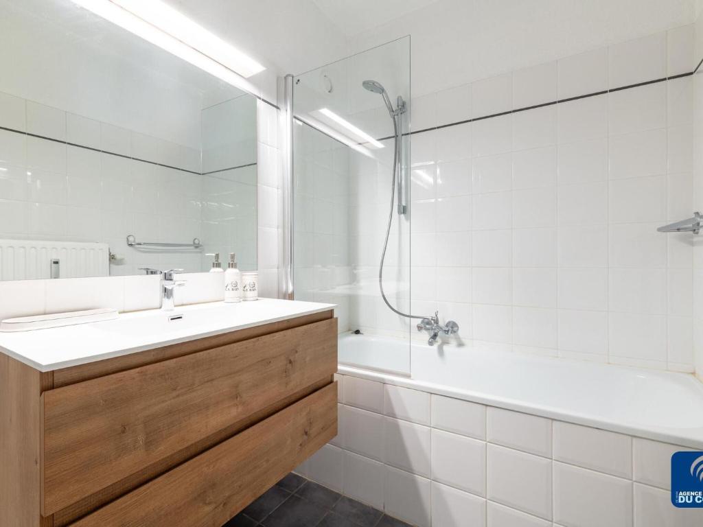 a bathroom with a sink and a tub and a shower at Lilyta B403 4A apartment in De Haan near the sea in De Haan