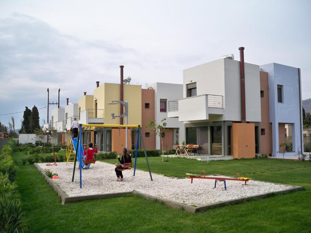 a group of people playing on a playground at Erodios Hotel in Karistos