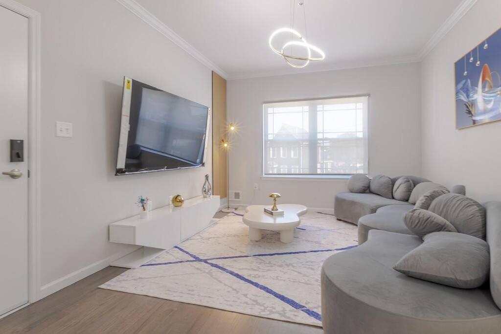 a living room with a couch and a flat screen tv at Beautiful 3bedroom apartment in Elizabeth