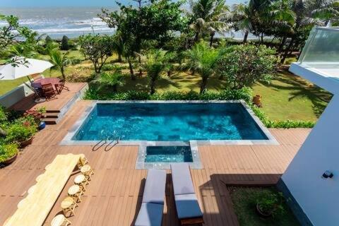 a swimming pool sitting on top of a wooden deck at D6 Aria Resort in Vung Tau