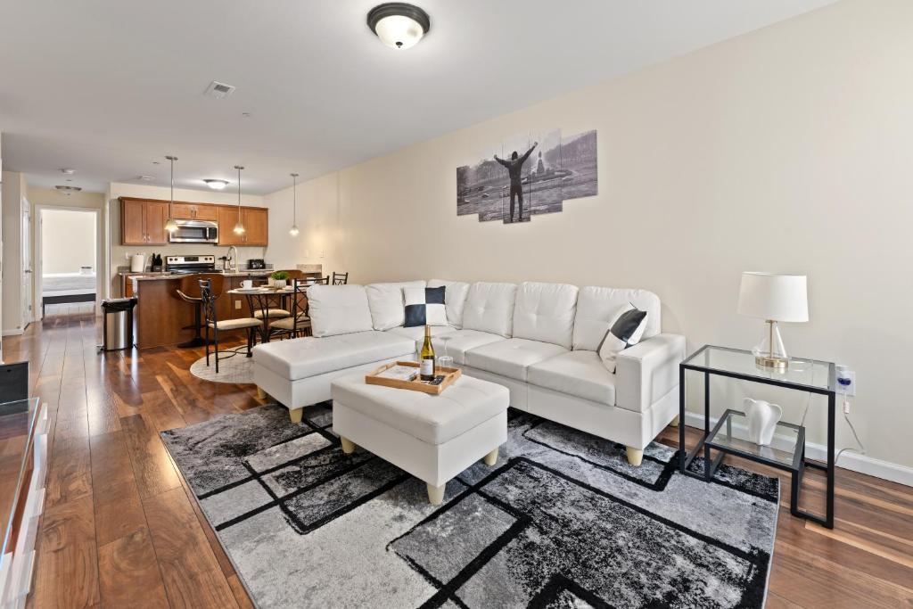 a living room with a white couch and a table at Hidden Gem in Philadelphia