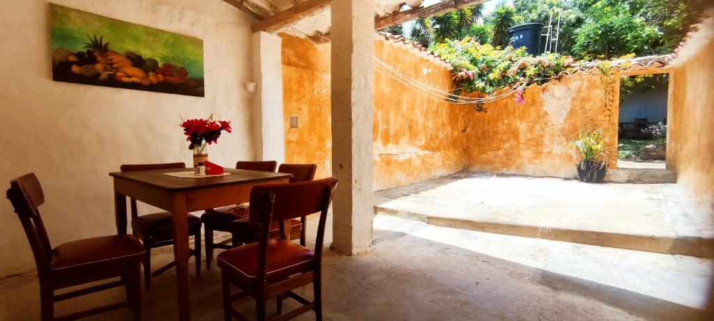 a room with a table and chairs and a window at Casa Orquidea Hostal Barichara in Barichara