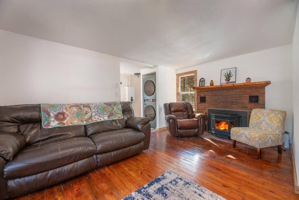 uma sala de estar com um sofá de couro e uma lareira em Wisconsin River relaxing retreat! em Rhinelander