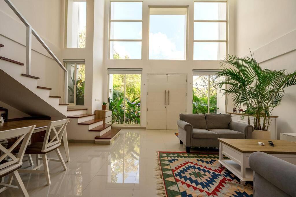 a living room with a couch and a table at The View Villa 2 - 2br Minimalist Villa in Uluwatu in Uluwatu