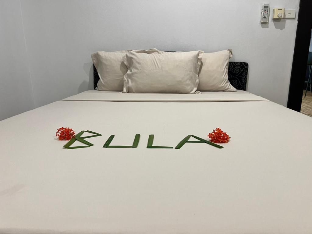 a white bed with alda written on the side of it at Garden Apartments in Nadi
