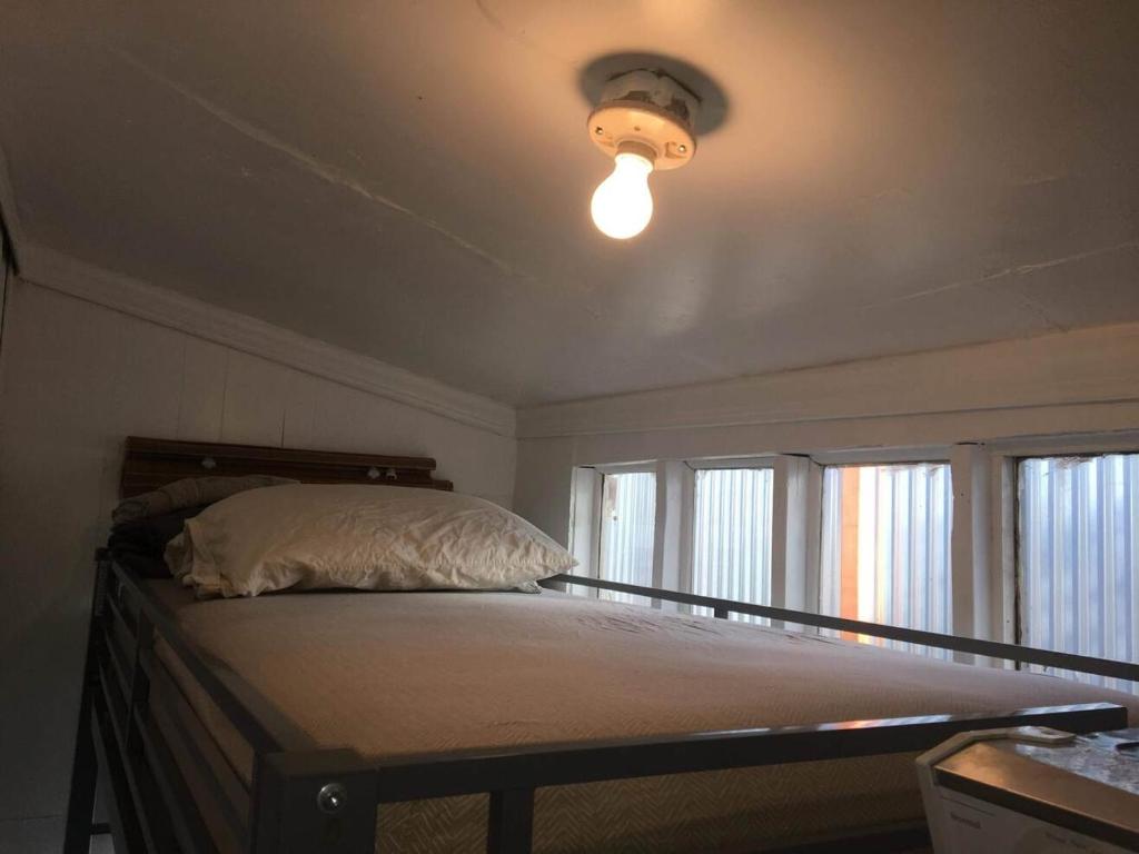1 dormitorio con 1 cama grande y techo luminoso en Skyline Vitali Siesta Couch Quarters in Heart of Echo Park DTLA Awaits, en Los Ángeles