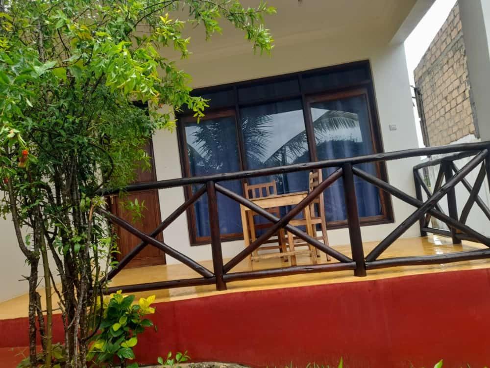 a front porch of a house with a balcony at Majani Breeze in Nungwi