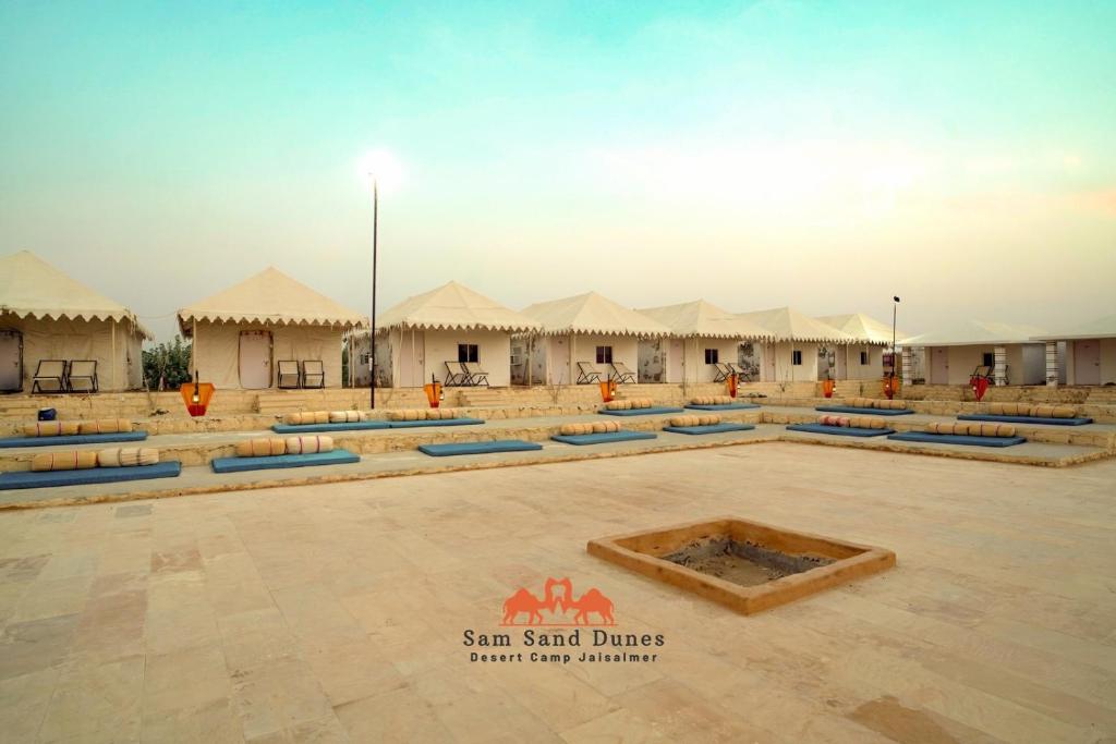 a courtyard of a compound with tents in the desert at Sam Sand Dunes Desert Safari Camp in Jaisalmer