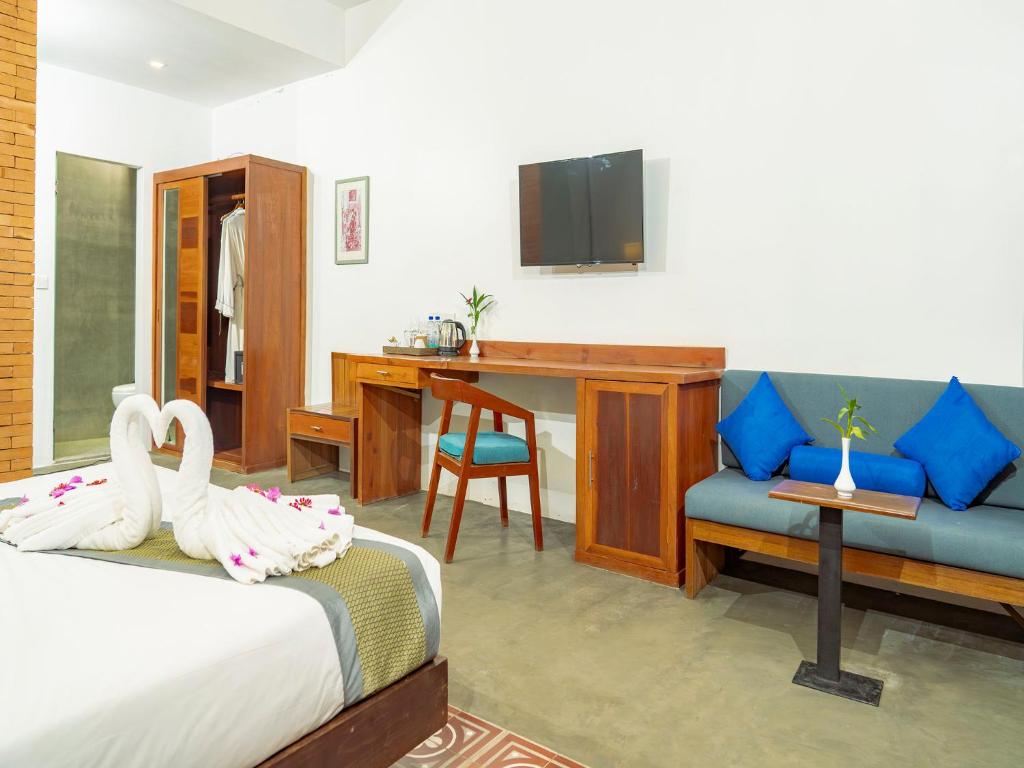 Postel nebo postele na pokoji v ubytování Tanei Angkor Resort and Spa