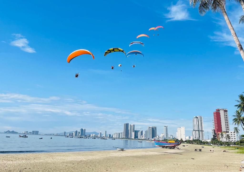 a group of people flying kites on a beach at Sontra Sea Hotel in Danang