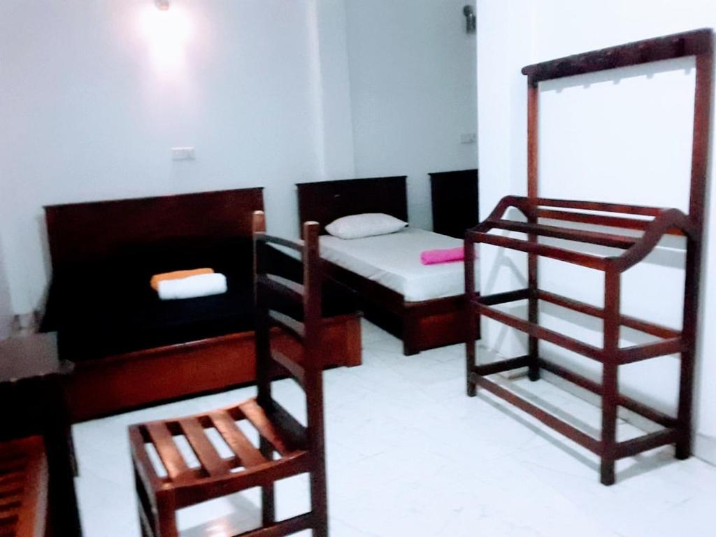 a room with two bunk beds and a mirror at Black And White Kandy Guest House 01 in Kandy