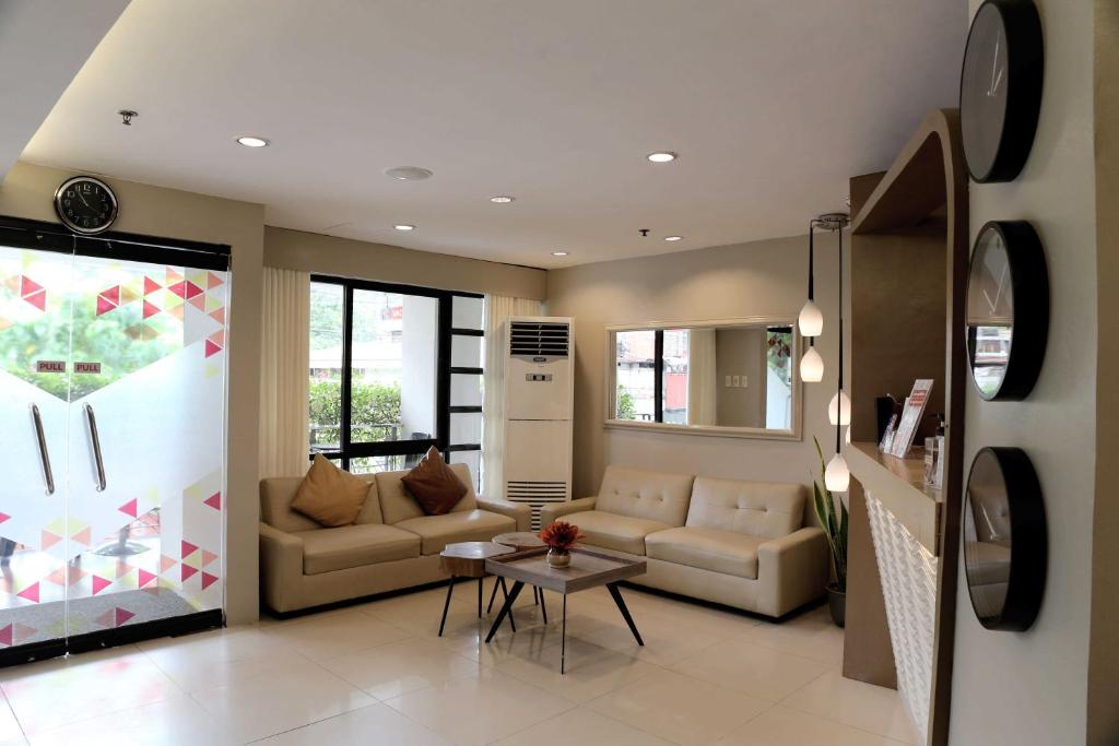 a living room with two couches and a table at Travelbee Business Inn in Cebu City