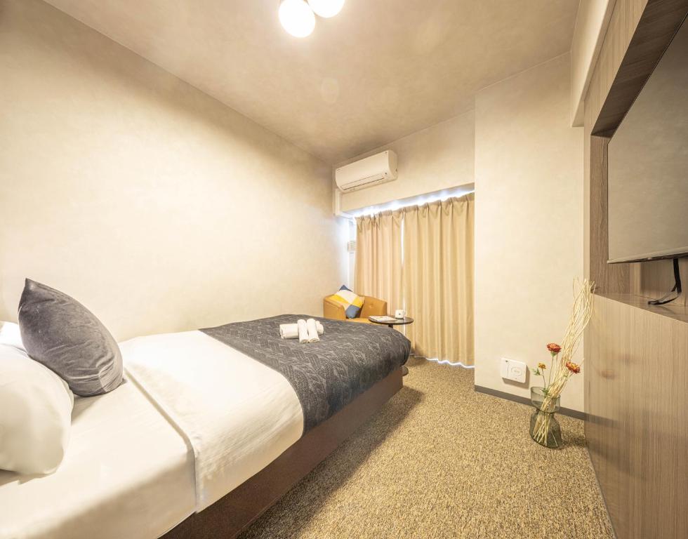 Postel nebo postele na pokoji v ubytování Apartment Hotel 11 Shinsaibashi 2