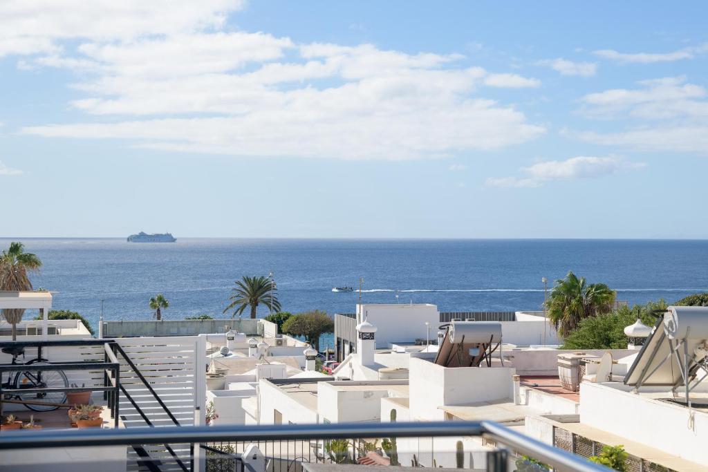 a view of the ocean from the balcony of a resort at APARTMENT TIMPLE Puerto del Carmen in Puerto del Carmen