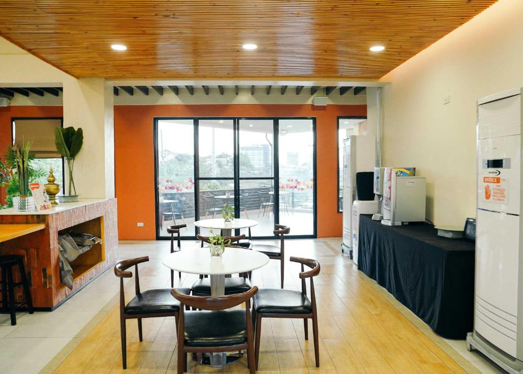 a room with a table and chairs and a kitchen at Travelbee Airport Inn in Mactan