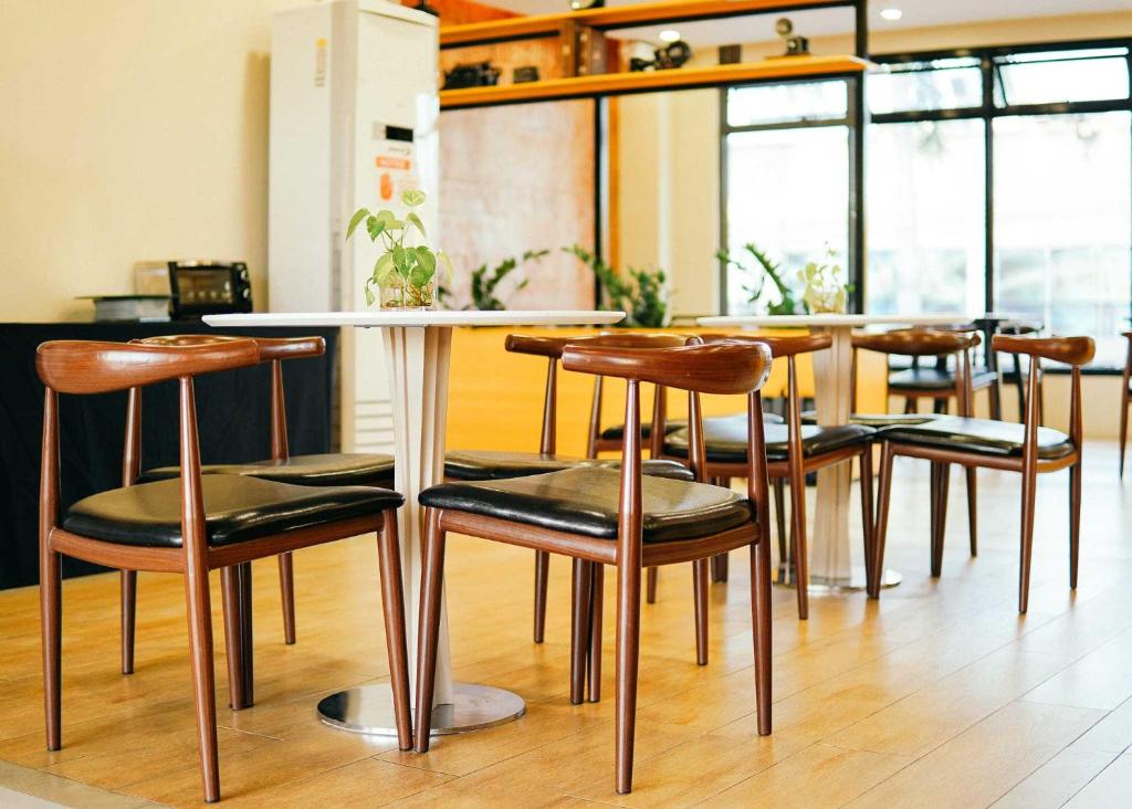 a group of chairs around a table in a room at Travelbee Airport Inn in Mactan